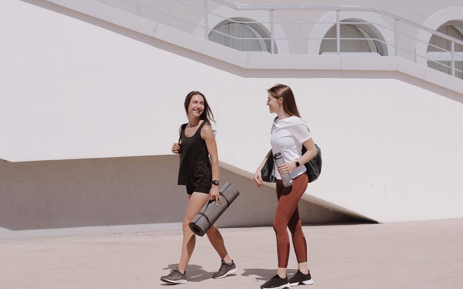 Two women walking together outdoors