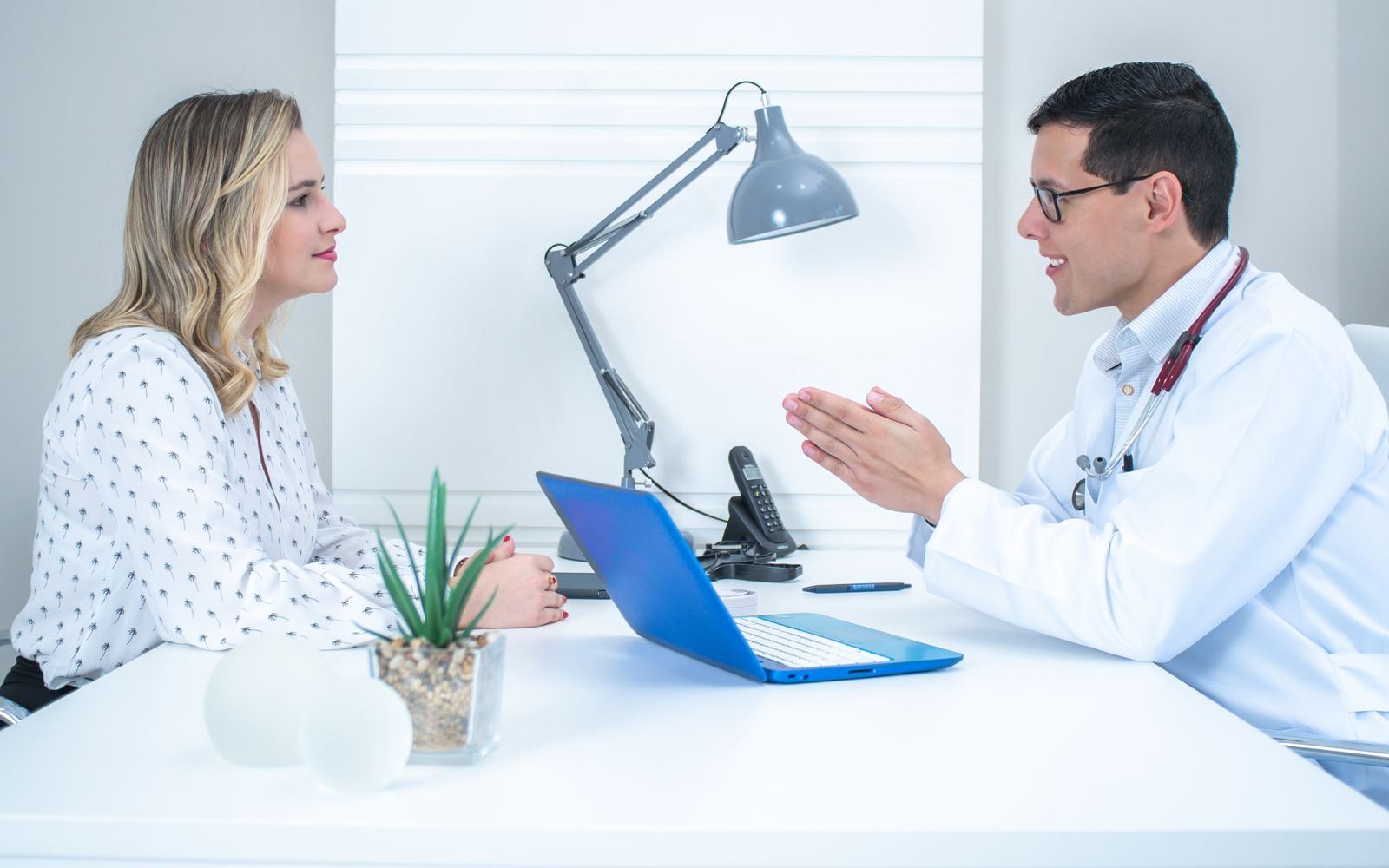 A doctor talking with a woman during a consultation