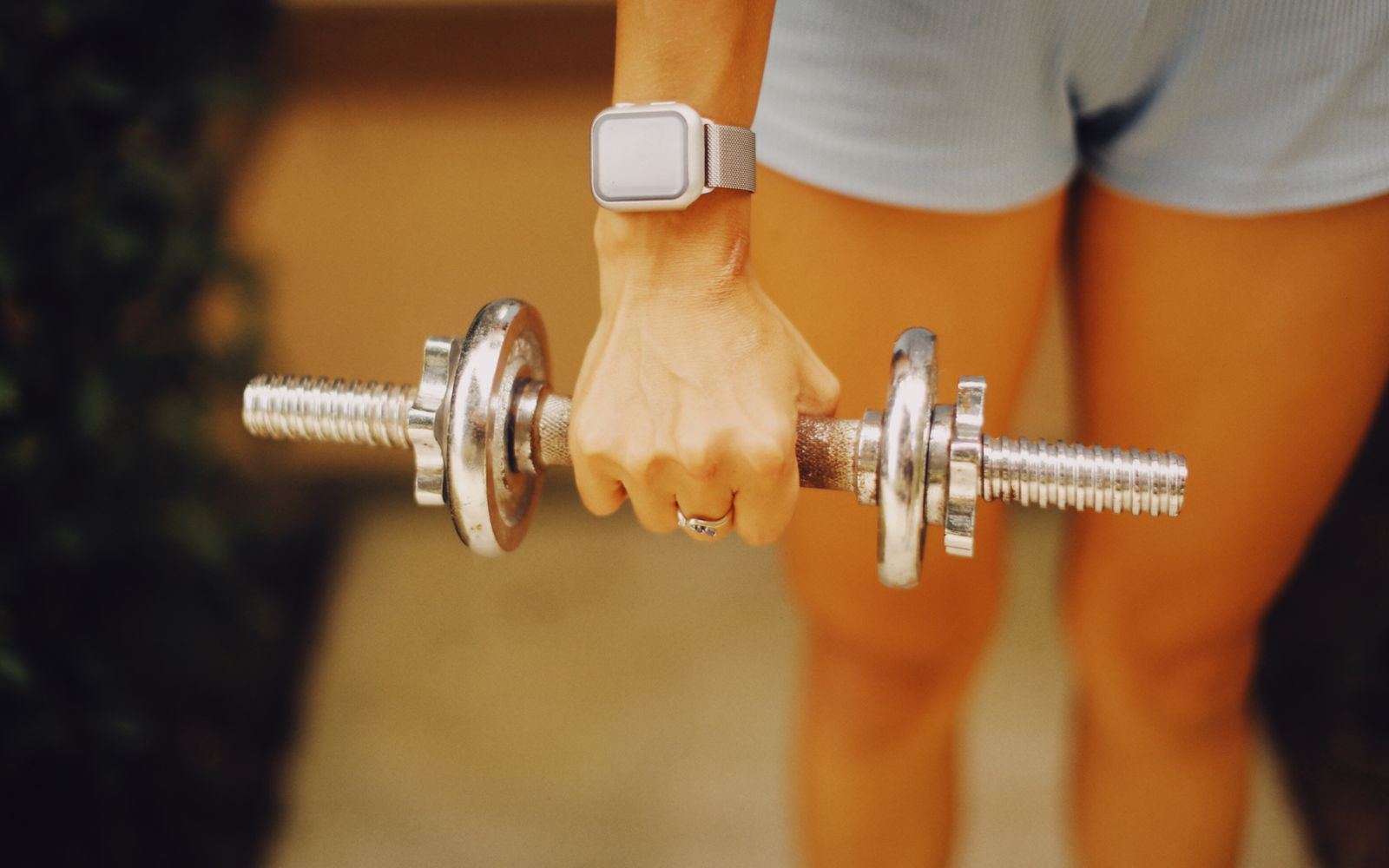 A woman holding a dumbbell during a home workout